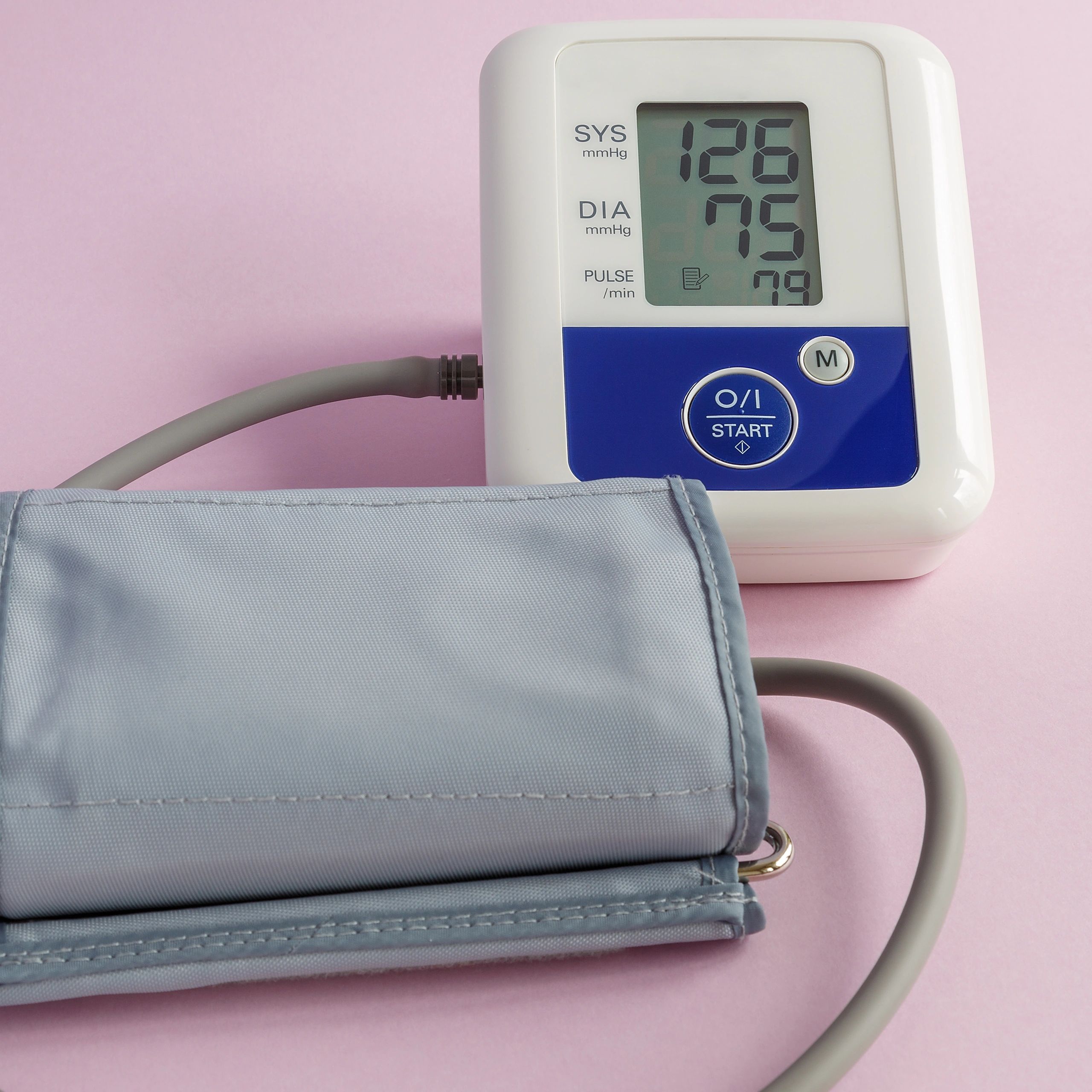 Digital blood pressure monitor on a dark surface